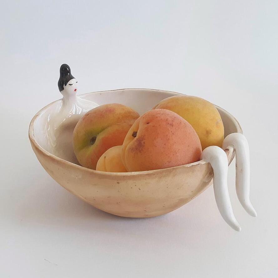 ceramic fruit bowl with woman figurine